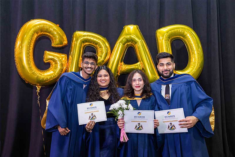 Students showing their diplomas