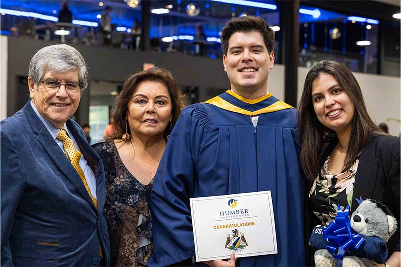 Student posing for photo with family