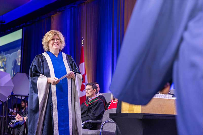 Humber President Holding Student Diploma