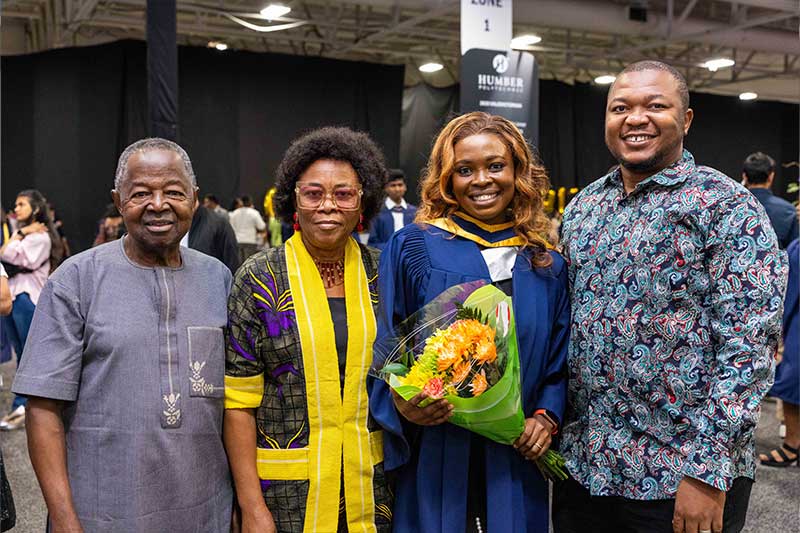 Student posing for photo with family