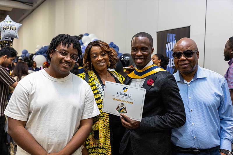 Student posing for photo with family