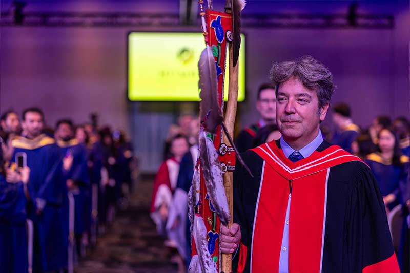 Person holding indigenous ceremonial staff