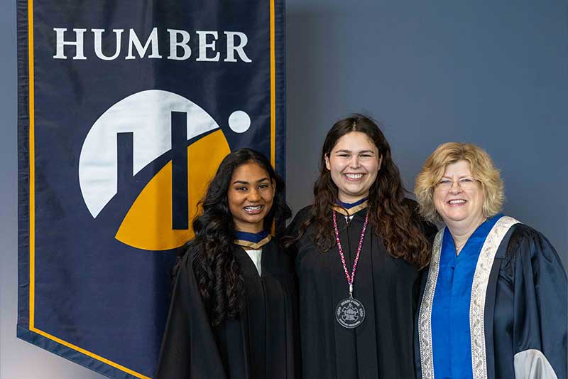 People posing in front of Humber Flag