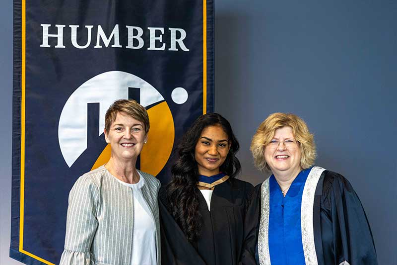 People posing in front of Humber Flag