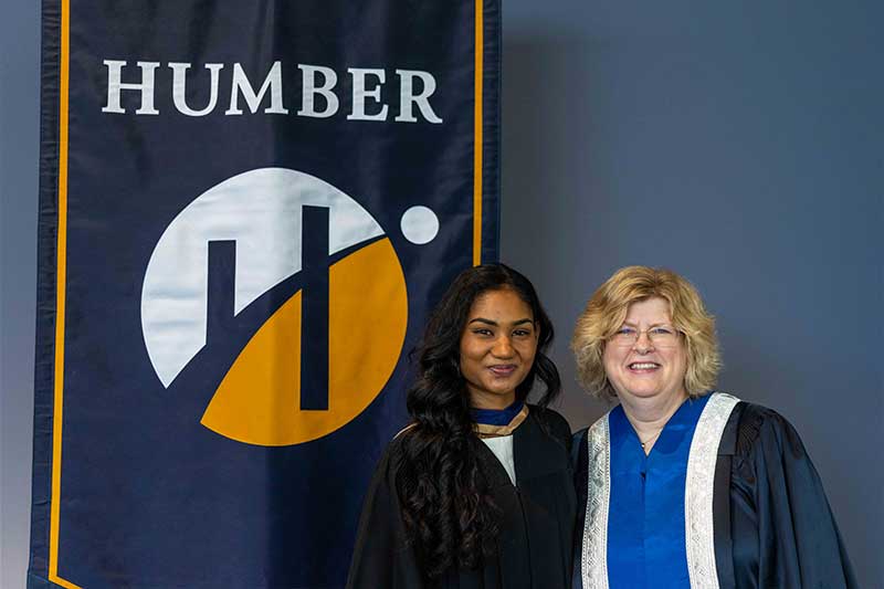 People posing in front of Humber Flag