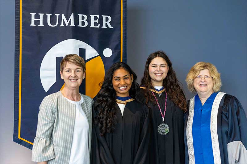 People posing in front of Humber Flag