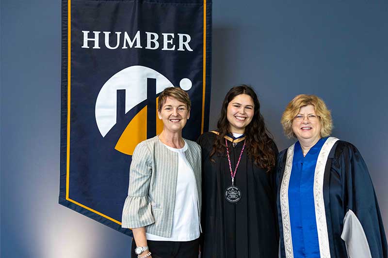 People posing in front of Humber Flag