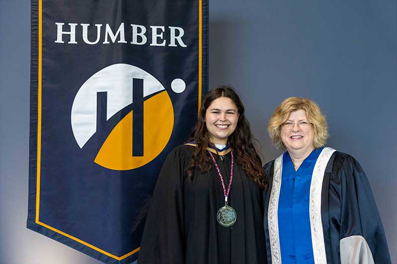 People posing in front of Humber Flag