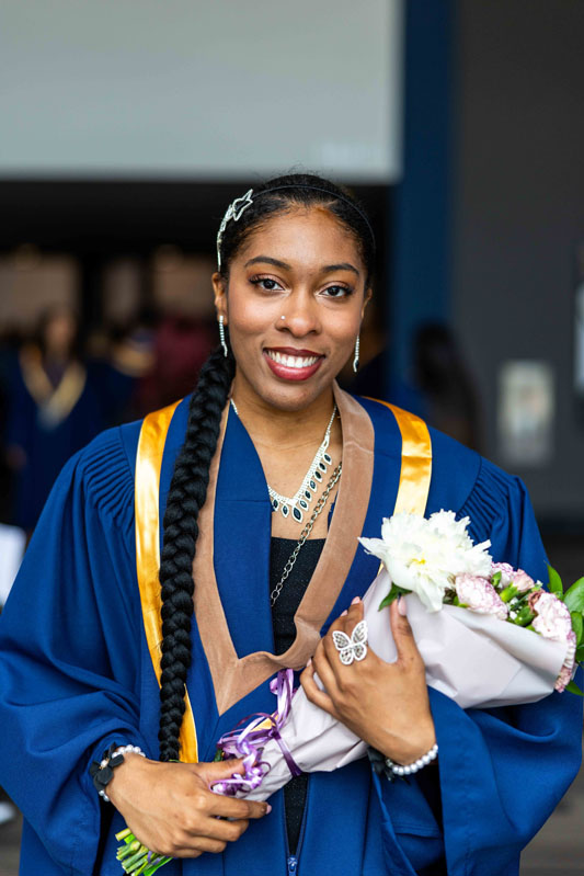 Student holding flowers