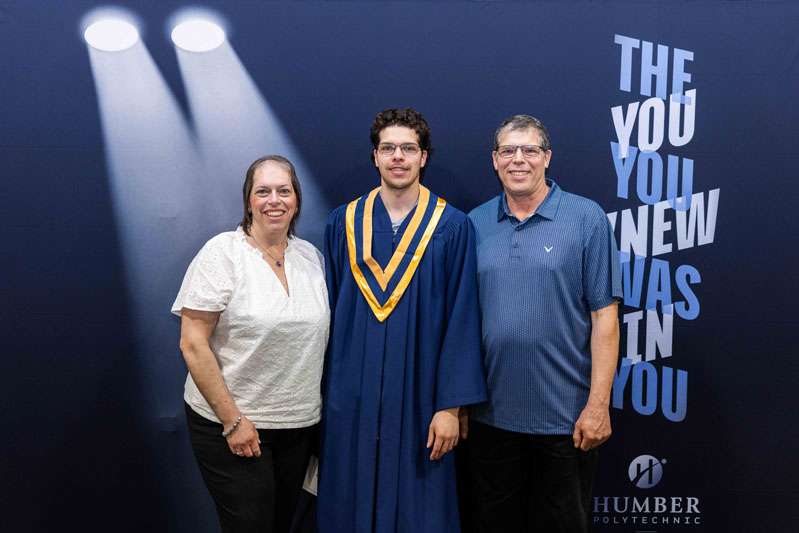 Family in front of Humber Banner wall