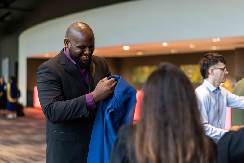 Person holding student robes