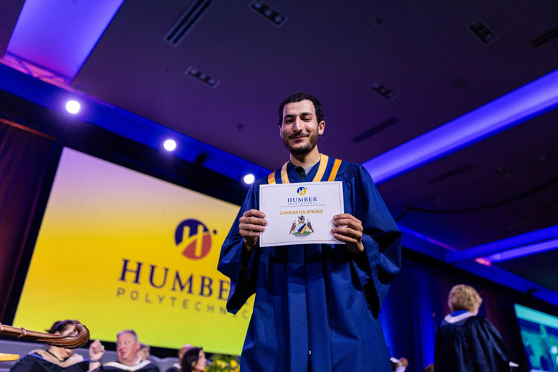 Student showing diploma