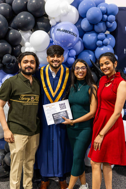Student posing for picture with family