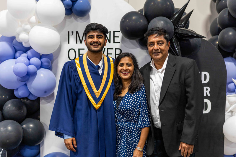 Student posing for picture with family