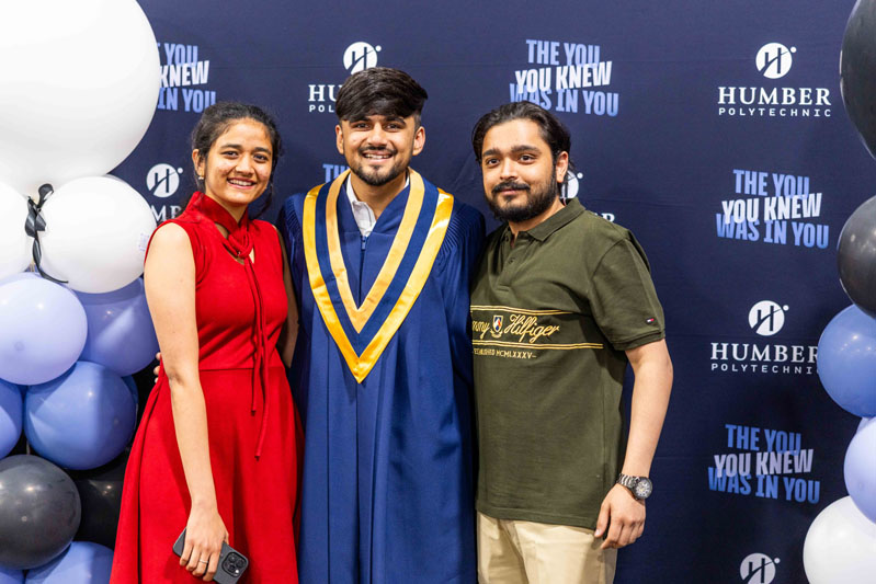 Student posing for picture with family