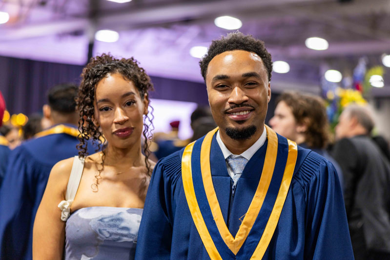 Student posing for picture with family