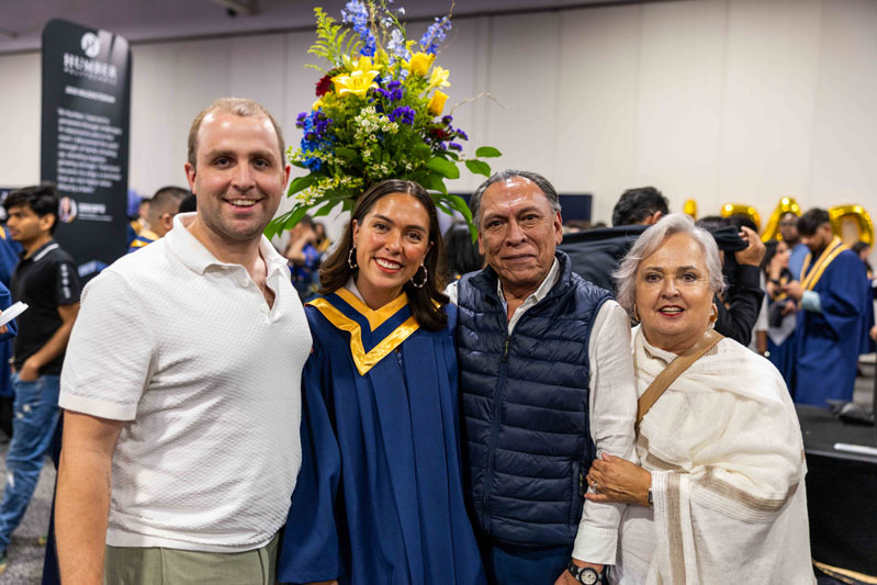 Student posing for picture with family