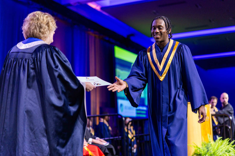 student receiving diploma