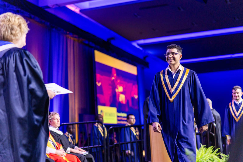 student receiving diploma