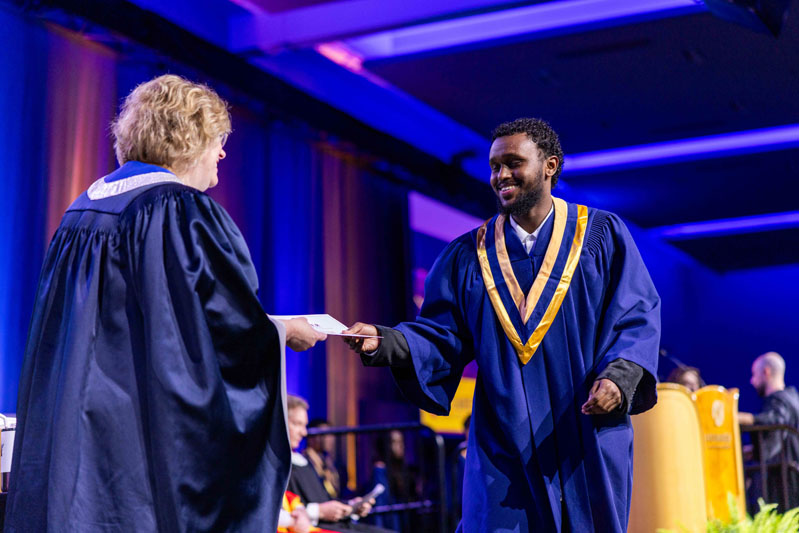 student receiving diploma