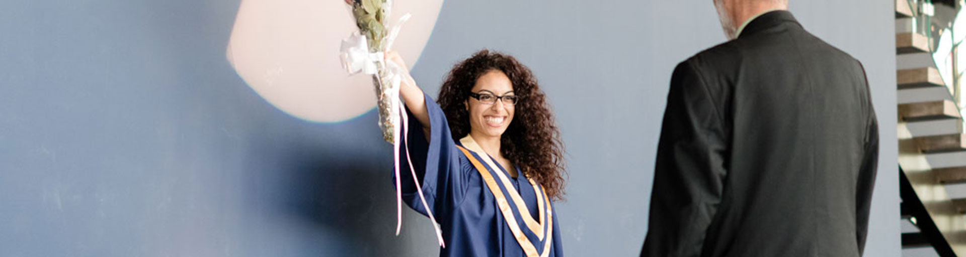 convocation front stage female holding up flowers