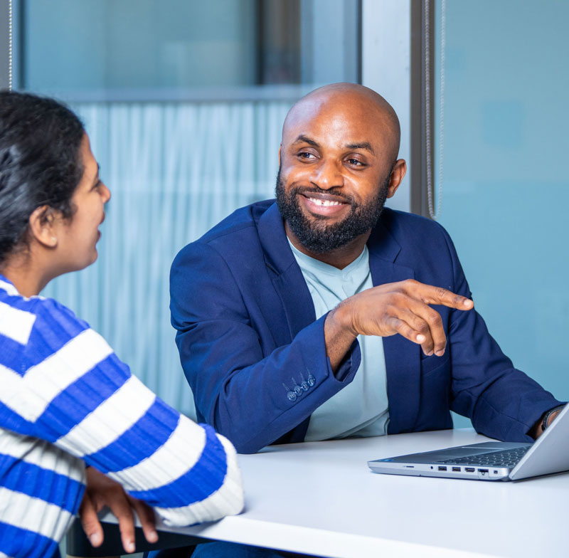 Person smiling pointing at laptop