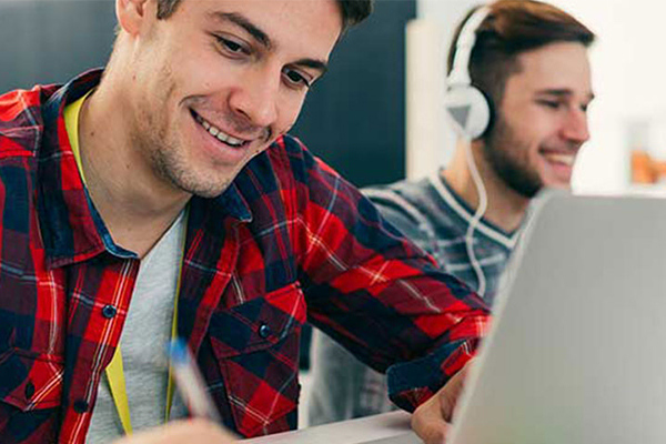 Man smiling at computer