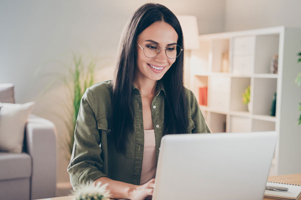 person smiling as they work on computer