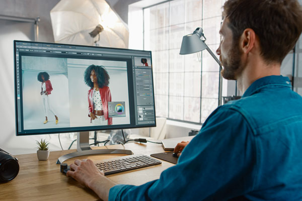 Person designing on Photoshop on computer