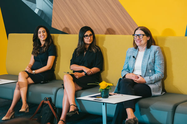 three professional women seated on couch