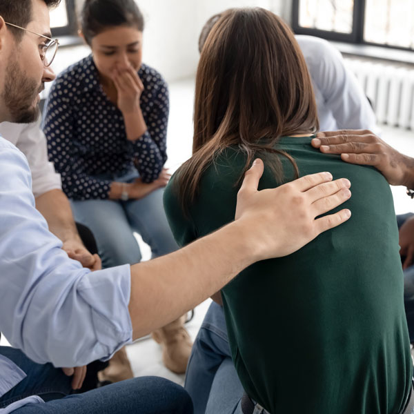 Person being comforted in group support session