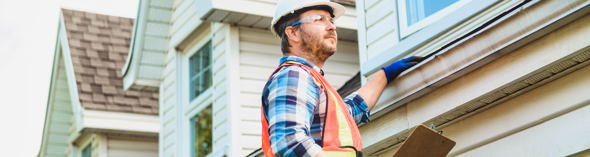professional home inspector looking at a roof