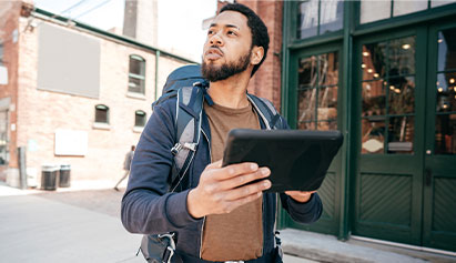 Man traveling while while holding an ipad