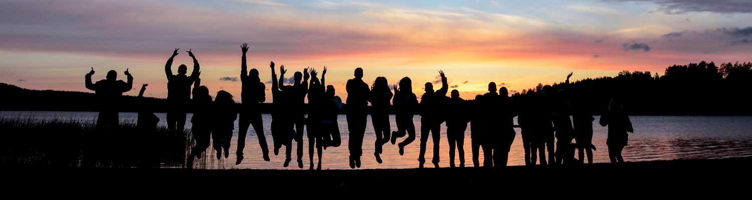 Students jumping in the sunset