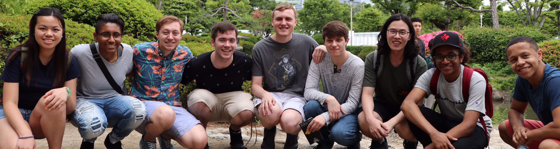 Group of people kneeling down smiling