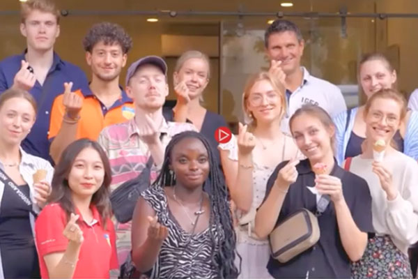 Group of people standing together all crossing fingers