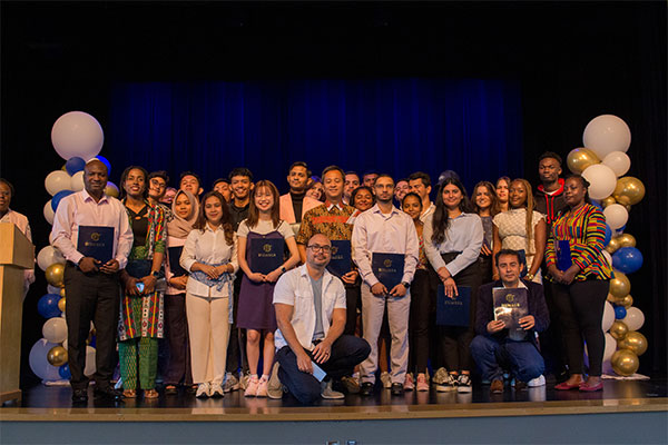 group of GSS students on stage holding diplomas