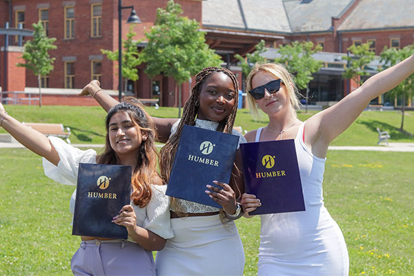 three GSS students holding diplomas