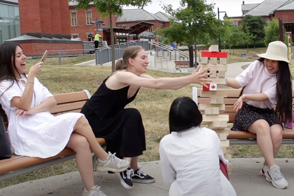 4 female GSS playing Jenga game