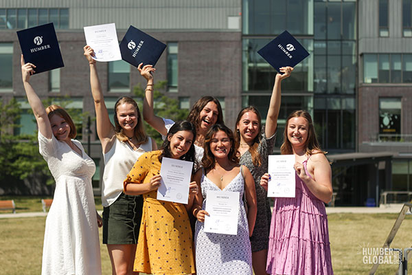 GSS students standing outside holding up their certificates