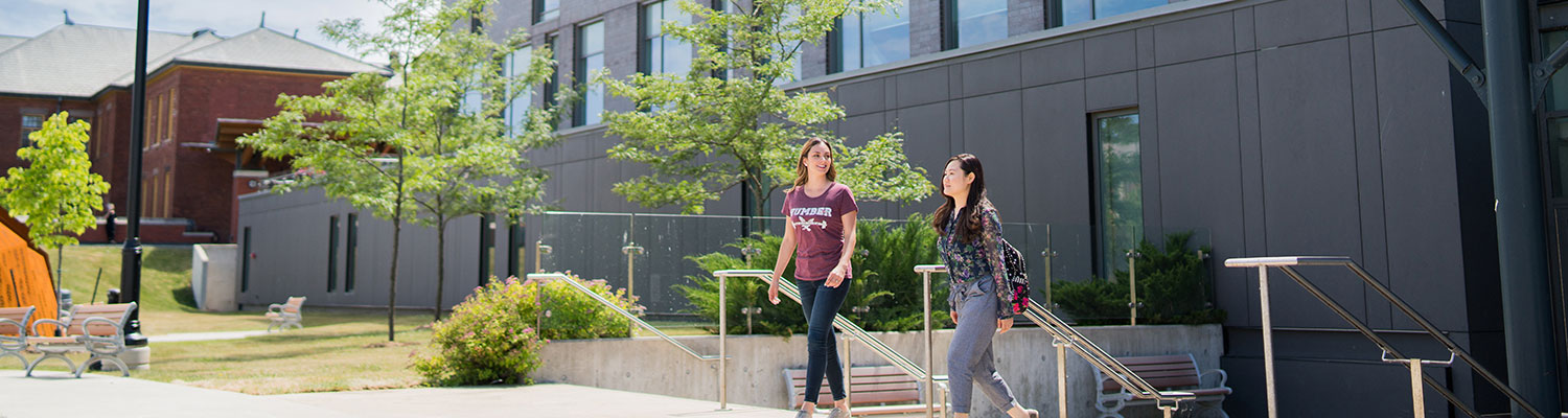 2 students walking outside of school