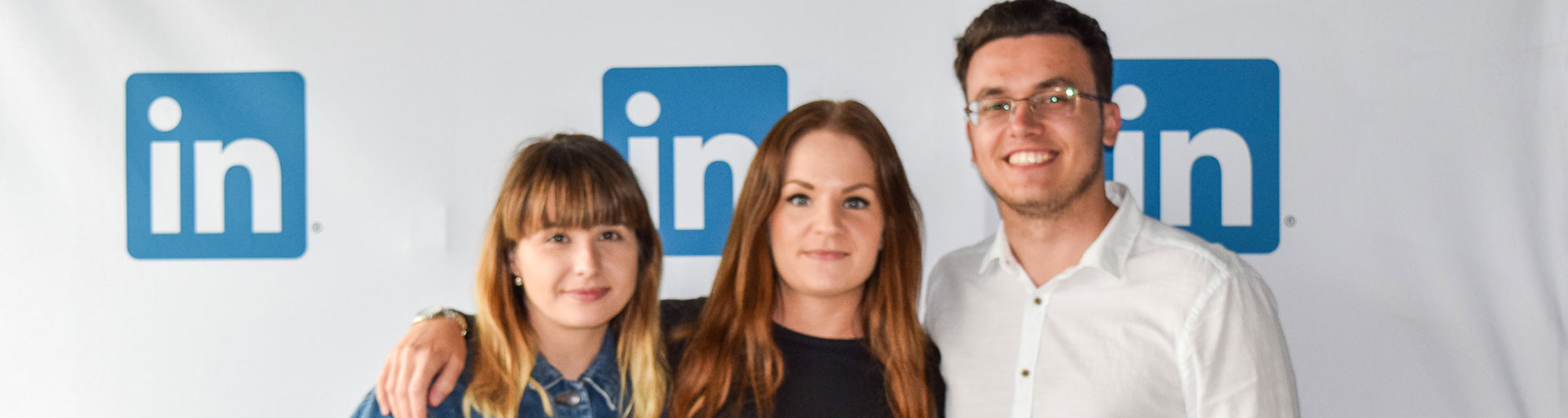 two female and a male standing for a photo
