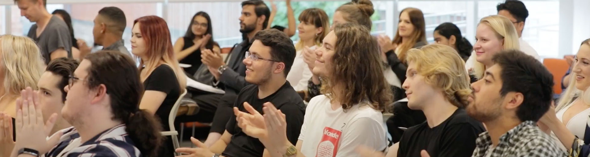 classroom of students clapping