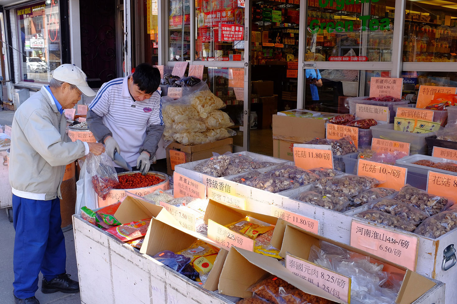 person at outside vegetable market