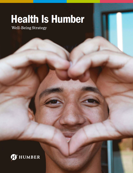 Image of a man looking through his hands which are making the shape of a heart.