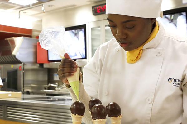 Person decorating dessert