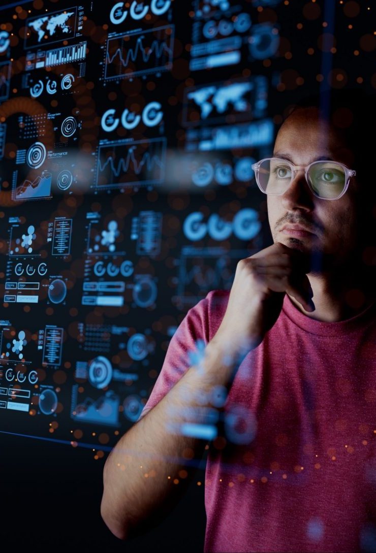 Man in glasses analyzing data visualizations on a transparent digital analytics dashboard interface