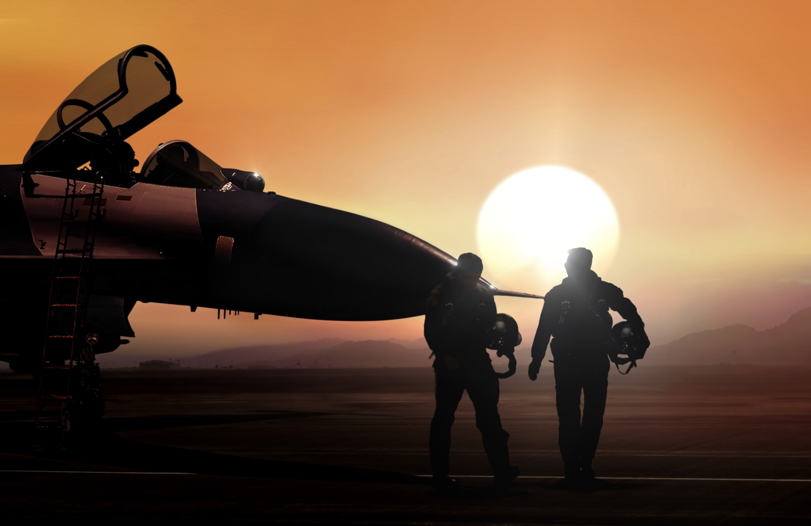 Two fighter pilots walking towards a fighter jet