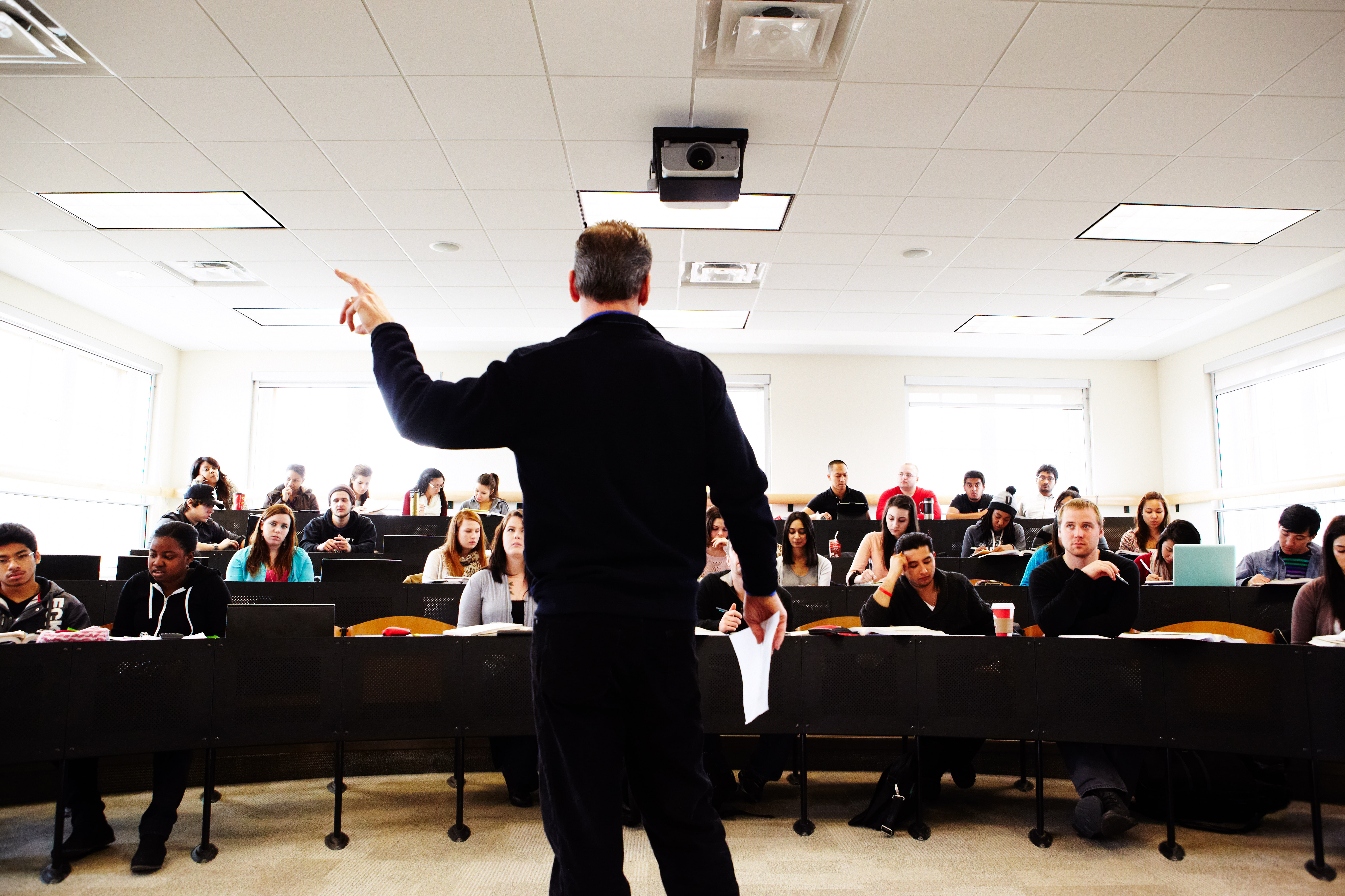 Instructor giving a lecture in a small lecture hall