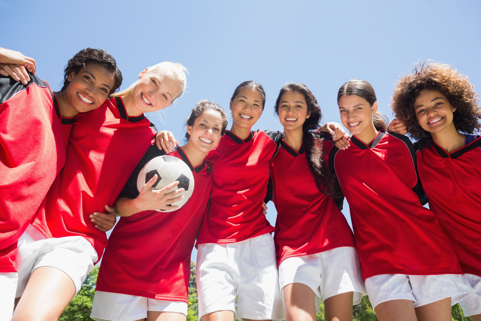 A smiling girls soccer team